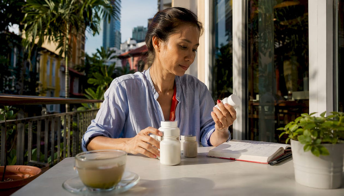 Woman reviewing beauty and sleep supplements at kitchen table