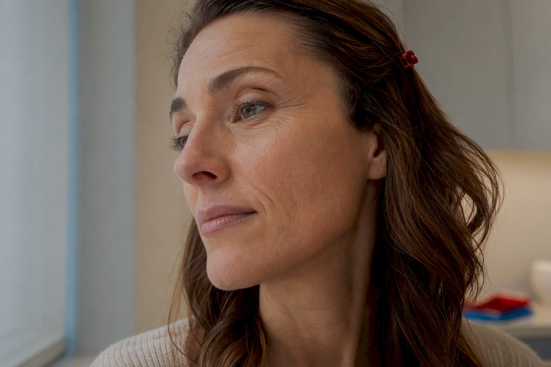 Woman examining natural facial fine lines