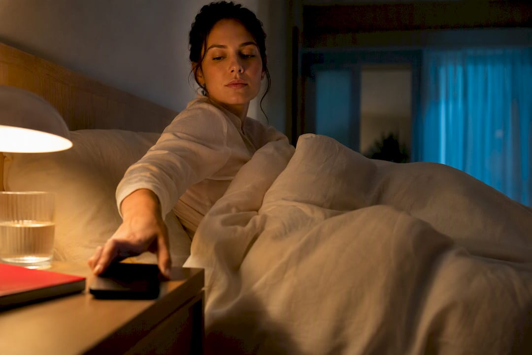 Adult turning phone face-down before sleep