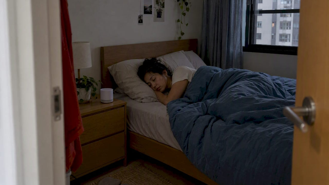 Sleeper beside a small bedside sound machine